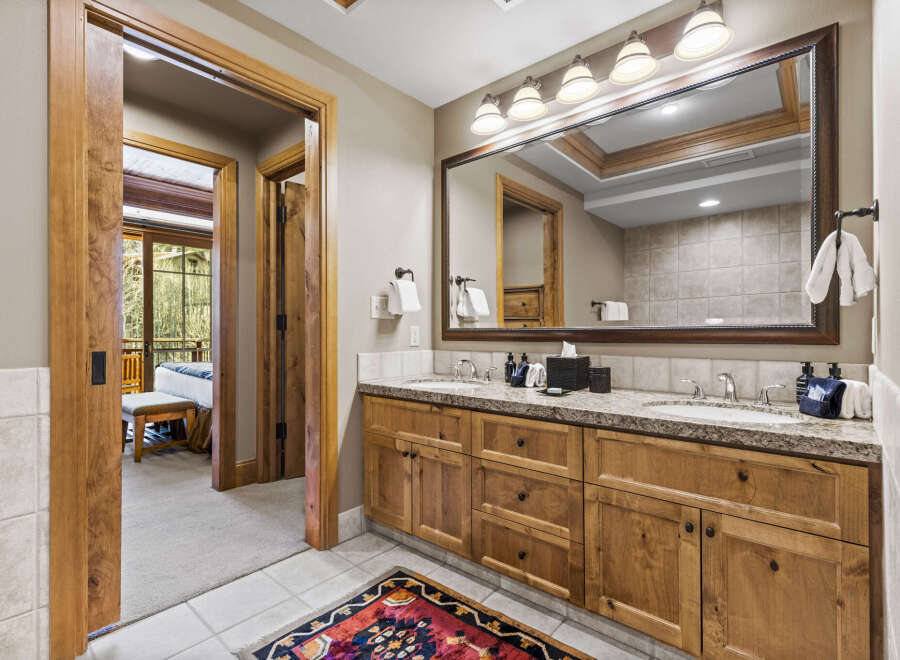 Step into luxury with this stunning bathroom, featuring exquisite wooden cabinetry and a spacious vanity.