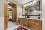 Step into luxury with this stunning bathroom, featuring exquisite wooden cabinetry and a spacious vanity.