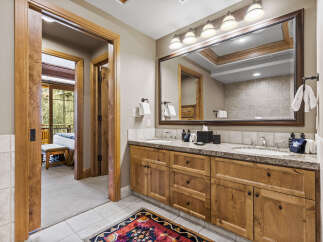 Step into luxury with this stunning bathroom, featuring exquisite wooden cabinetry and a spacious vanity.
