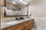 This stunning bathroom features a double vanity with a granite countertop, offering ample space for daily routines.