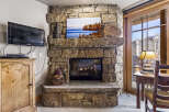 This stunning property boasts a cozy living space centered around a beautiful stone fireplace, perfect for those chilly evenings.