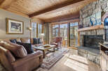 Step into luxury with this stunning living space, featuring a cozy fireplace and elegant wooden accents.