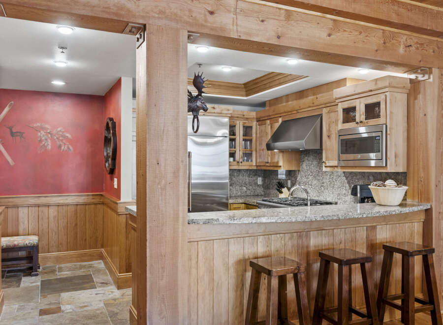 This stunning kitchen boasts a rustic charm with its wooden accents and inviting ambiance.