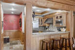 This stunning kitchen boasts a rustic charm with its wooden accents and inviting ambiance.