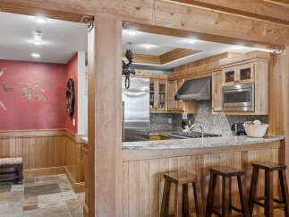 This stunning kitchen boasts a rustic charm with its wooden accents and inviting ambiance.