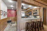 Step into rustic elegance with this stunning property, showcasing a beautifully designed kitchen with custom wood cabinetry and a sleek stainless steel refrigerator.