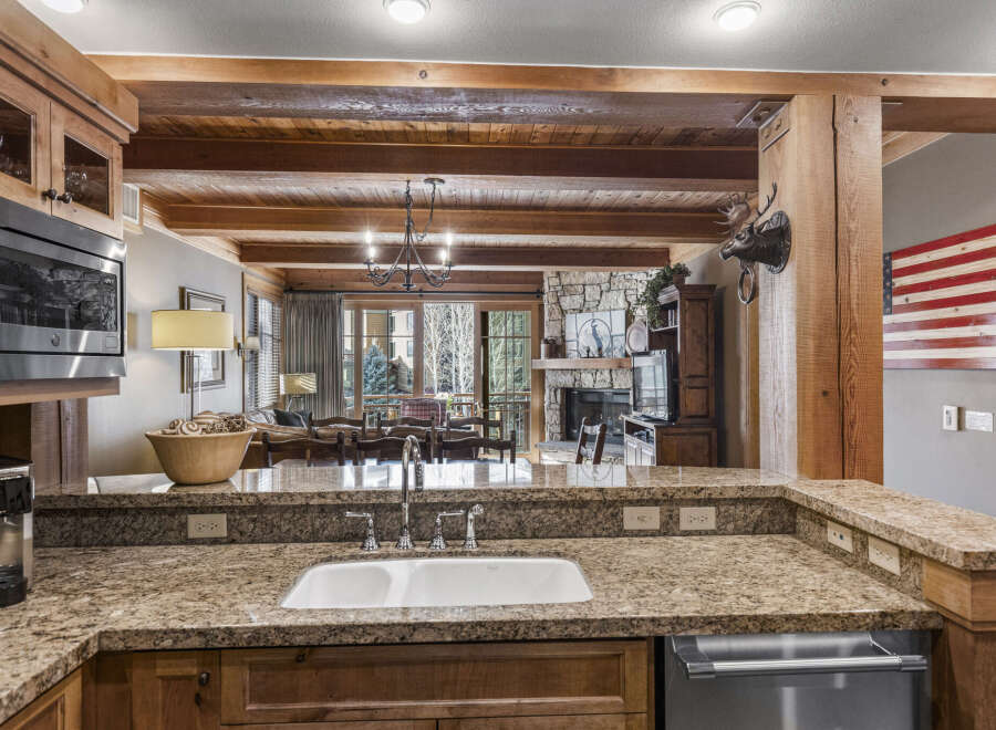 Step into luxury with this stunning kitchen, featuring granite countertops and custom cabinetry.