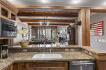 Step into luxury with this stunning kitchen, featuring granite countertops and custom cabinetry.
