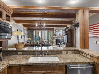 Step into luxury with this stunning kitchen, featuring granite countertops and custom cabinetry.