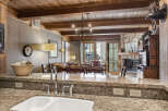 This stunning property boasts a beautifully designed kitchen with granite countertops and a modern sink.