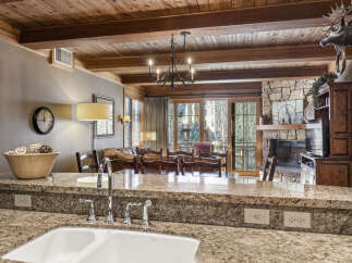 This stunning property boasts a beautifully designed kitchen with granite countertops and a modern sink.