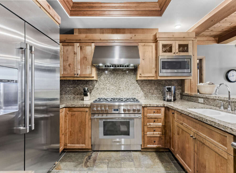 This stunning kitchen boasts high-end appliances and custom cabinetry, perfect for the discerning chef.
