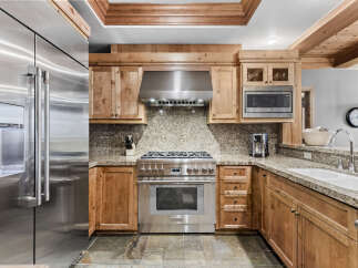 This stunning kitchen boasts high-end appliances and custom cabinetry, perfect for the discerning chef.