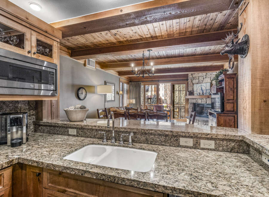 Step into luxury with this stunning kitchen, featuring granite countertops and custom cabinetry.