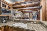 Step into luxury with this stunning kitchen, featuring granite countertops and custom cabinetry.