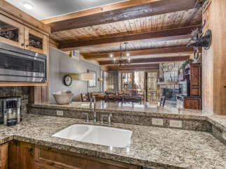 Step into luxury with this stunning kitchen, featuring granite countertops and custom cabinetry.
