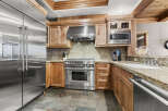 This stunning kitchen boasts top-of-the-line stainless steel appliances, including a refrigerator, range, and microwave.