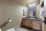 Step into this beautifully designed bathroom, featuring a rustic wooden vanity and a stylish countertop.