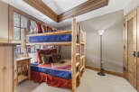 This cozy bedroom features a rustic bunk bed, perfect for a vacation home or a kid's room.