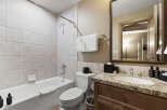 This beautiful bathroom features a modern design with a sleek vanity and a spacious bathtub.