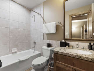 This beautiful bathroom features a modern design with a sleek vanity and a spacious bathtub.