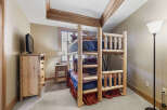 This charming bedroom features a rustic bunk bed, perfect for accommodating guests or family.