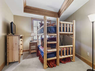 This charming bedroom features a rustic bunk bed, perfect for accommodating guests or family.