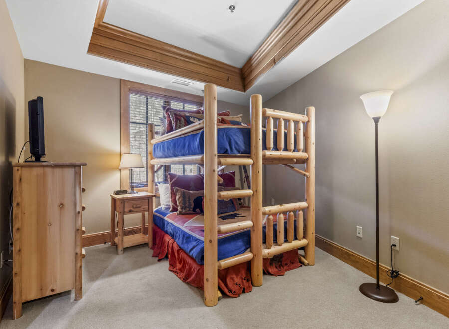 This charming bedroom features a rustic bunk bed, perfect for a cozy retreat.