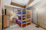 This charming bedroom features a rustic bunk bed, perfect for a cozy retreat.