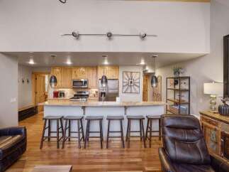 This stunning property boasts a modern kitchen with granite countertops and stainless steel appliances, perfect for culinary enthusiasts.