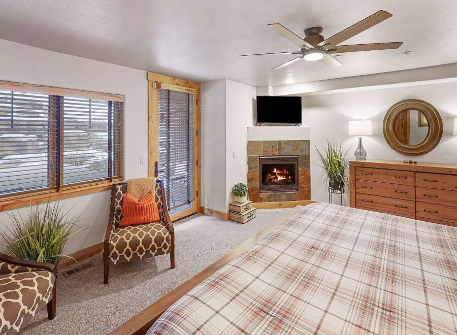 Experience luxury in this stunning bedroom featuring a cozy fireplace, perfect for those chilly evenings.