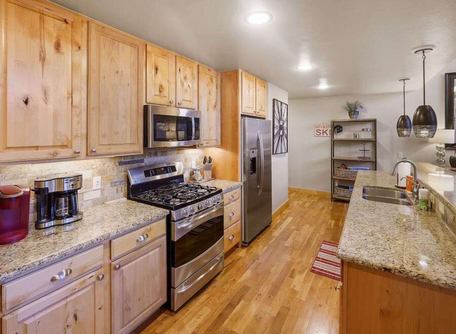 This stunning kitchen boasts beautiful wooden cabinetry, offering ample storage and a warm, inviting atmosphere.