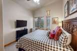 This cozy bedroom features a stylish black and white checkered bedspread, creating a welcoming atmosphere.