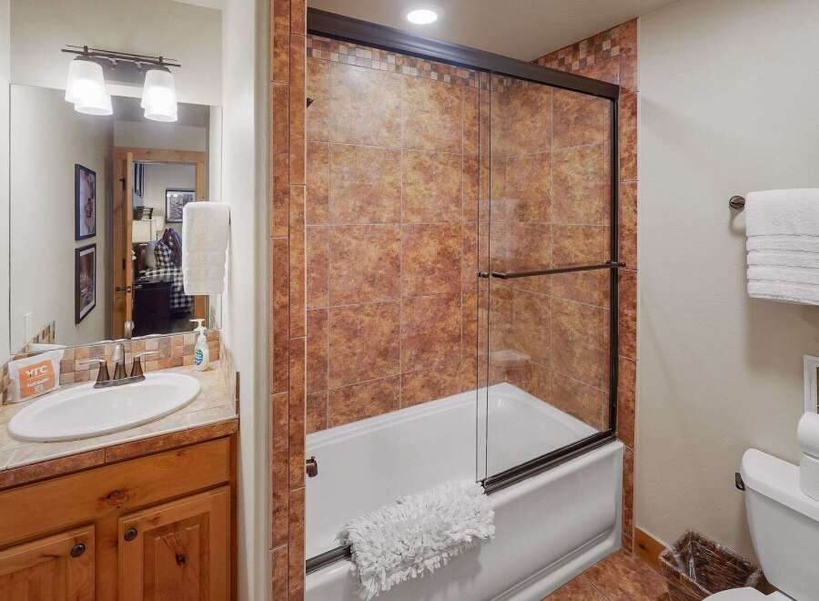 This bathroom features a stylish combination of rustic and modern elements.
