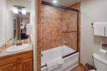 This bathroom features a stylish combination of rustic and modern elements.