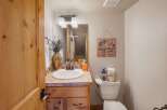 Step into this charming bathroom, featuring a rustic wooden vanity and a stylish sink.