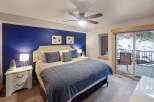 This stunning bedroom boasts a vibrant blue accent wall, creating a cozy and inviting atmosphere.