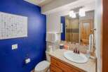 This stunning bathroom boasts a vibrant blue accent wall, creating a bold and inviting atmosphere.