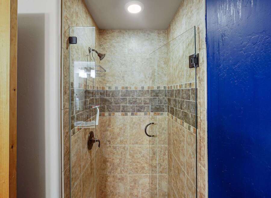 Step into a beautifully designed bathroom with a modern shower.