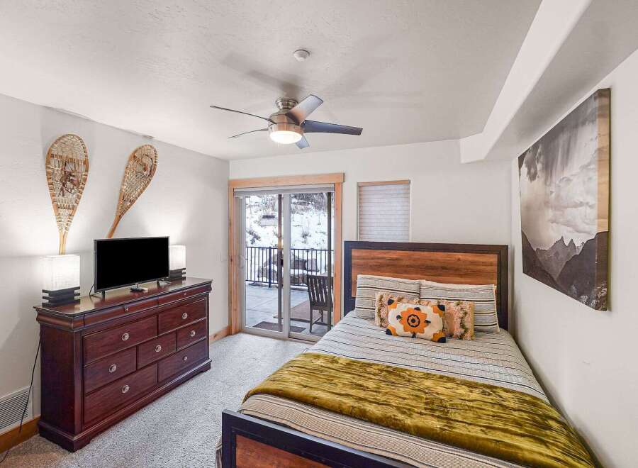 This cozy bedroom offers a serene retreat with its inviting ambiance and stylish decor.