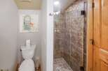 Step into this charming bathroom featuring a stylish shower and a cozy toilet area.