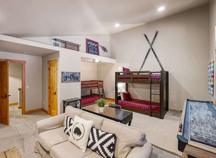 This stunning property boasts a cozy living area with a comfortable sofa and decorative pillows.