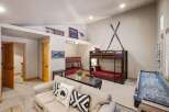 This stunning property boasts a cozy living area with a comfortable sofa and decorative pillows.