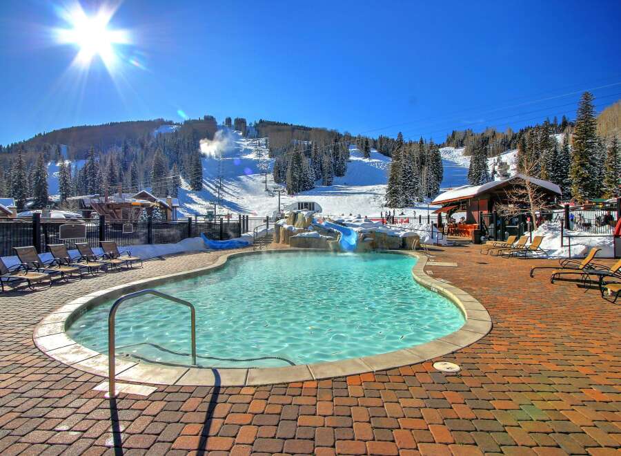 Enjoy the ultimate winter getaway at this stunning property! Featuring a heated outdoor pool with a waterslide, perfect for relaxing after a day on the slopes.
