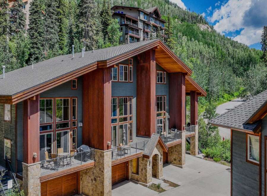 Experience luxury mountain living in this stunning multi-level home, featuring expansive windows that capture breathtaking forest and mountain views.