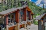 Experience luxury mountain living in this stunning multi-level home, featuring expansive windows that capture breathtaking forest and mountain views.