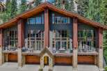 Experience luxury mountain living in this stunning multi-level home, featuring expansive windows that flood the interior with natural light and showcase breathtaking forest views.