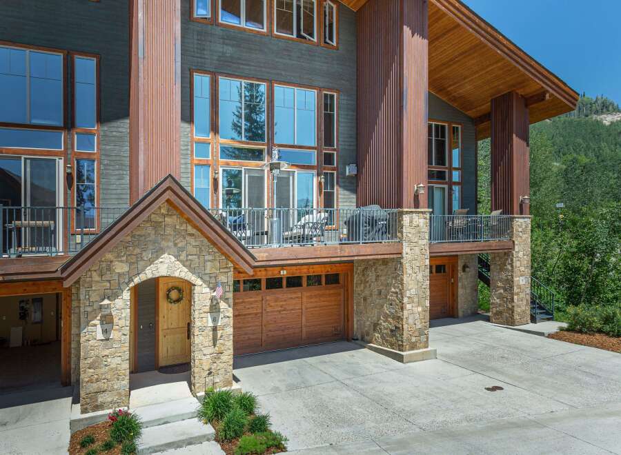 Experience luxury mountain living in this stunning modern home, featuring expansive windows that capture breathtaking natural light and scenic views.