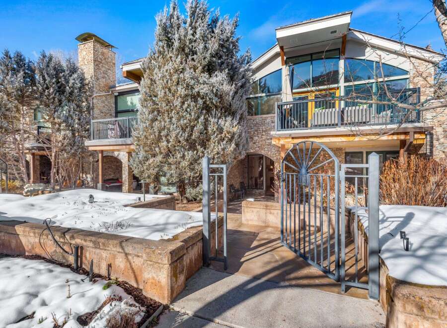 This stunning property boasts a beautiful exterior with stone accents and a modern design.