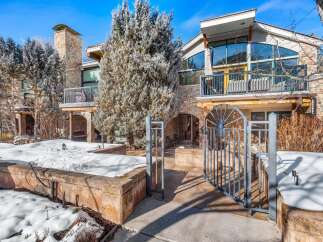 This stunning property boasts a beautiful exterior with stone accents and a modern design.